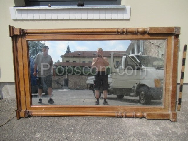 Mirror in a massive wooden light frame