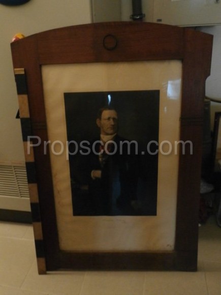 Photo of a man in a suit glazed in a frame