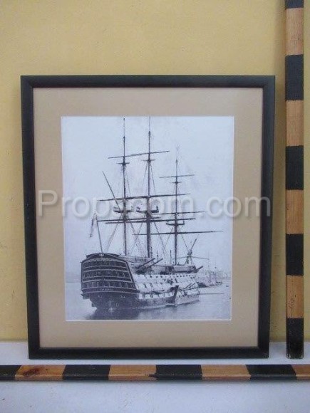 An image of a historic sailboat with sailed sails