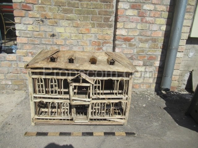Large wooden cage in the shape of a house