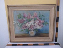 An image of a vase with lilacs