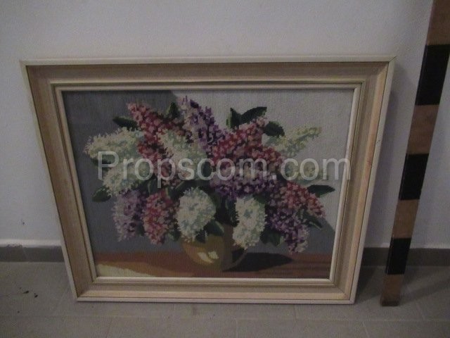 An image of a vase with lilacs