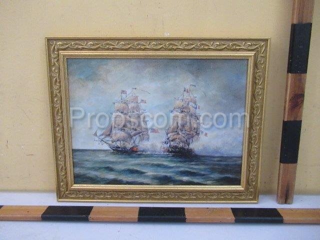 An image of two historic sailboats in a gold frame