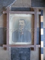 Photo of a man with a mustache glazed in a frame