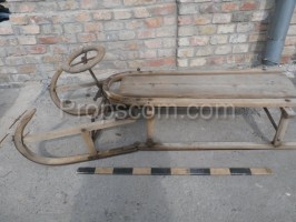 Wooden sled with steering wheel