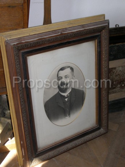 Photo of a man with a mustache glazed in a frame