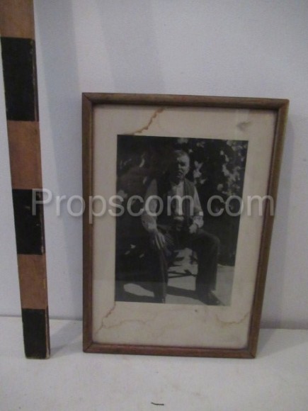 Sitting senior man photo glazed in a frame