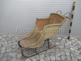 Wooden sled with a wicker chair