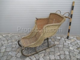 wooden sled with wicker chair