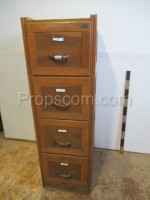 File cabinet with brass handles and labels