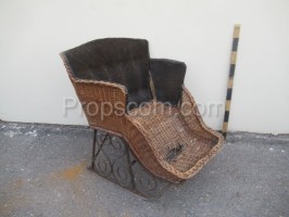 Children's forged sledge with a wicker chair