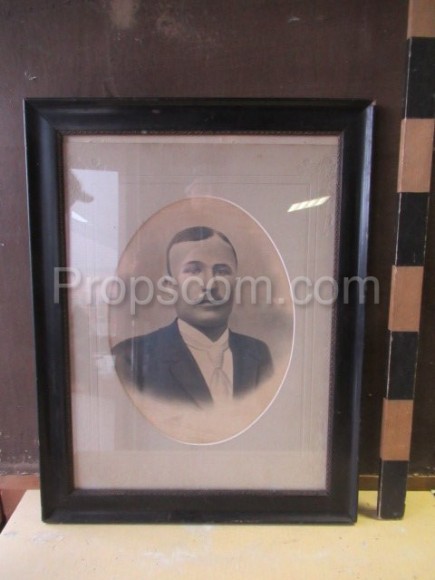 Fotografie muž s knírkem zasklená v rámu