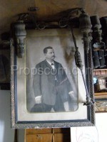 Photo of a man with a hat in a suit in a frame