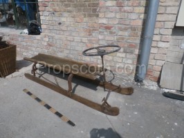 Wooden sled with steering wheel