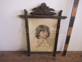 portrait of a little girl in a wooden ornate frame