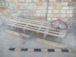 Wooden sled with steering wheel