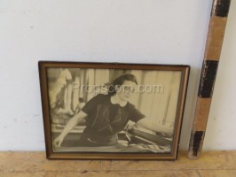 Photo of a seamstress glazed in a frame